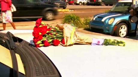 Biloxi Police Chief John Miller placed flowers on a patrol vehicle in tribute to the late officer Robert McKeithen.