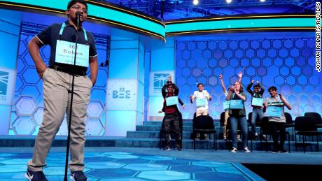 Rohan Raja, 13, of Irving, Texas, spells the last word in competition as the remaining competitors celebrate an eight way tie.