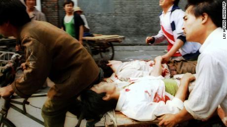 On June 4, a rickshaw driver pedals wounded people, with the help of bystanders, to a nearby hospital in Beijing after they were injured during clashes with Chinese soldiers in Tiananmen Square.
