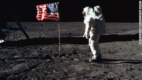 376713 03: (FILE PHOTO) Astronaut Edwin E. Aldrin, Jr., the lunar module pilot of the first lunar landing mission, stands next to a United States flag July 20, 1969 during an Apollo 11 Extravehicular Activity (EVA) on the surface of the Moon. The 30th anniversary of Apollo&#39;s moon landing is celebrated July 20, 1999. (Photo by NASA/Newsmakers)