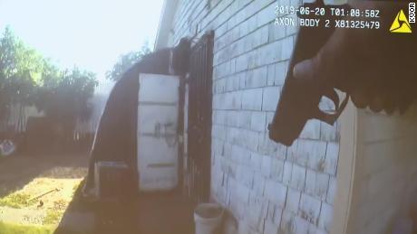 Body camera footage shows police approach the garage before the suspect fired.