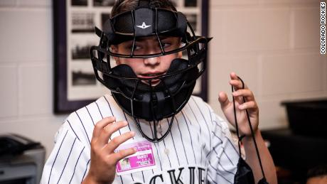 Josh Cordova tried on a new umpire mask, a gift from the Rockies. 