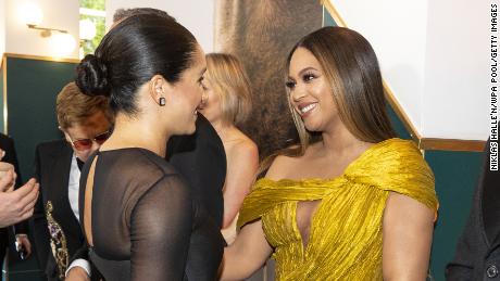 Meghan, Duchess of Sussex, on the left, meets Beyoncé as she attends Disney's European premiere 