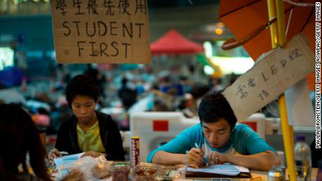 Students do their homework at a study area occupied as part of the Umbrella Movement on October 10, 2014, in Hong Kong.