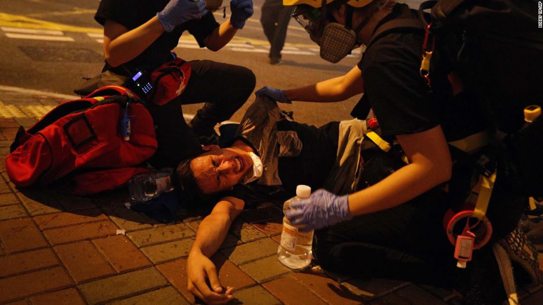 Medical workers help a protester affected by tear gas on July 21.