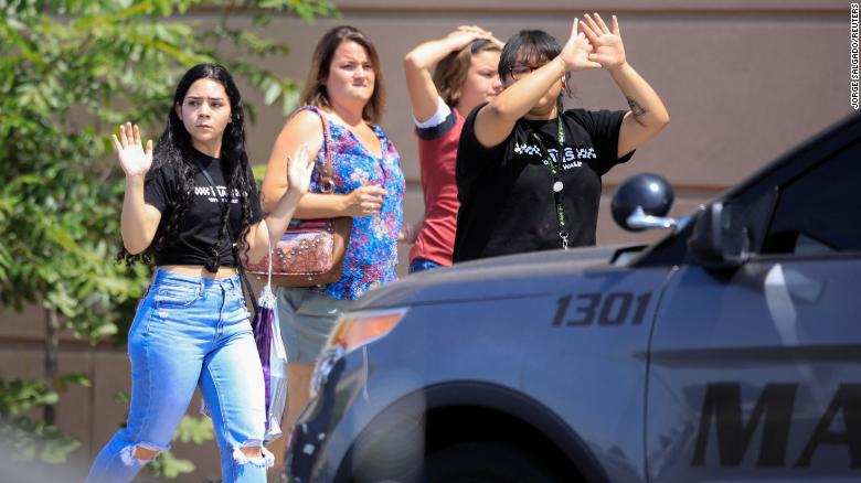 Shoppers exit with their hands up after a mass shooting at a Walmart in El Paso, Texas, U.S. August 3, 2019. 