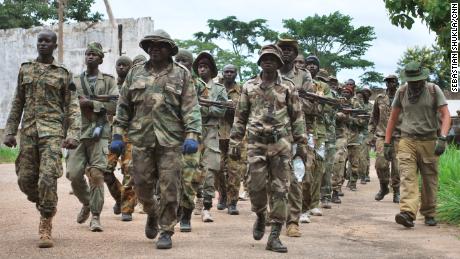 Central African Army (FACA) soldiers march with their Russian instructors to Berengo, which was once the palace of former CAR president Jean-Bedel Bokassa.  Recently these recruits have been fighting to repel insurgent attacks across the country.