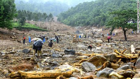 Volunteers, local residents and members of National Disaster Response Force search for survivors in the debris left by a landslide at Puthumala at Meppadi in the Wayanad district.
