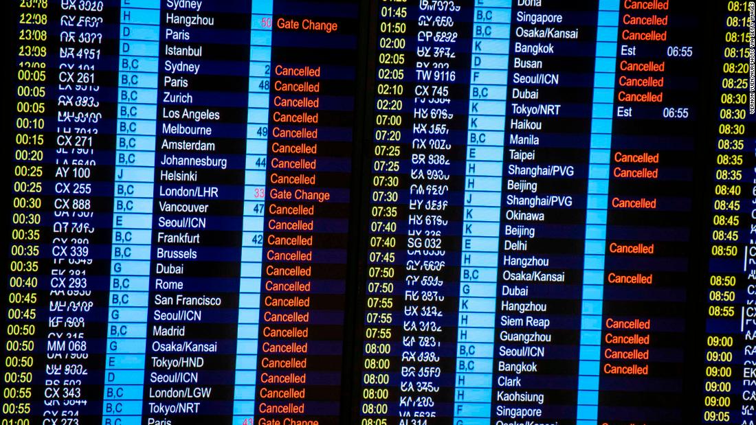 A display board shows canceled flights on August 13.