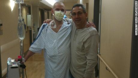 David Fajgenbaum poses with his father during one of his stays at the hospital.