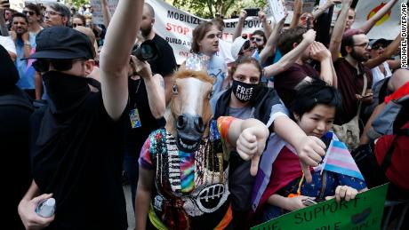 Counter-candidates, including one wearing a horse mask, lined the Straight Pride parade in Boston on Saturday, August 31, 2019.