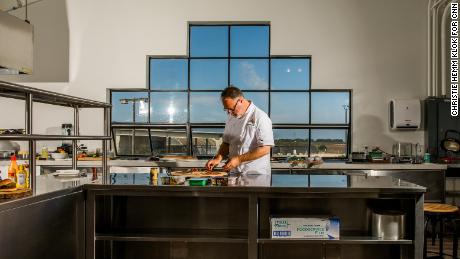 Tucker Bunch, Chef of Culinary Innovation and Development at Sweet Earth, prepares dishes in the kitchen test desk. 