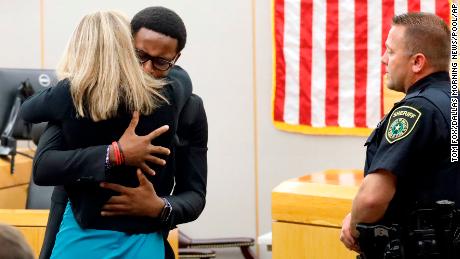 Botham Jean&#39;s younger brother Brandt Jean hugs convicted murderer and former Dallas Police Officer Amber Guyger.