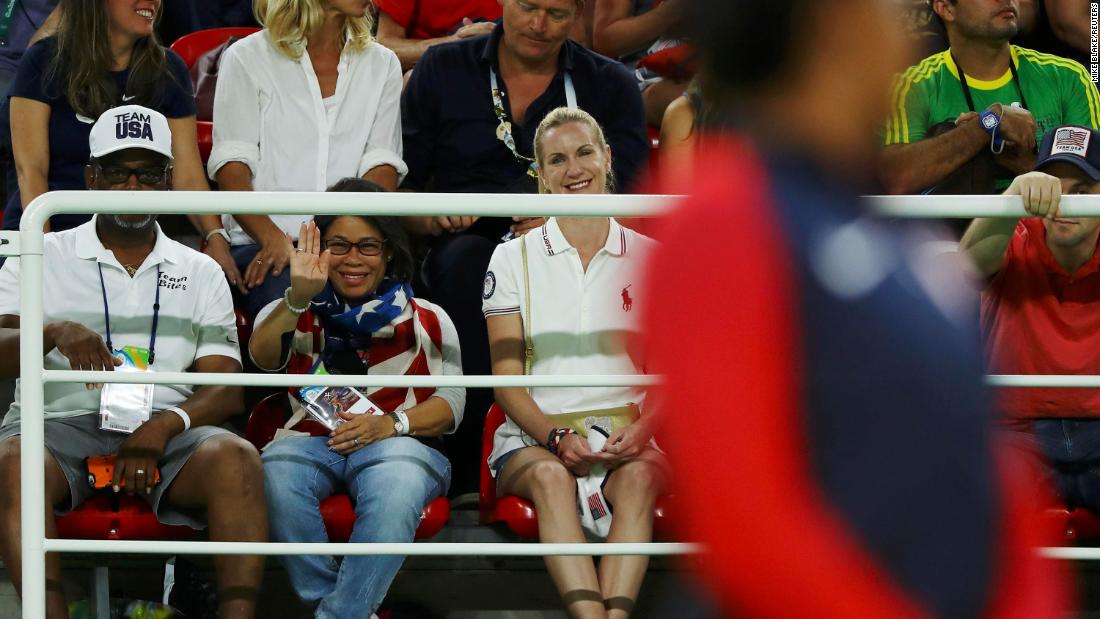 Biles&#39; grandfather, Ron Biles, and his wife, Nellie, watch as she waits on the podium to receive her gold medal after winning the floor final of the 2016 Olympics. They took in Simone and her younger sister, Adria, and then formally adopted them when Simone was just 6 because Simone&#39;s mom was battling addiction to drugs and alcohol. 