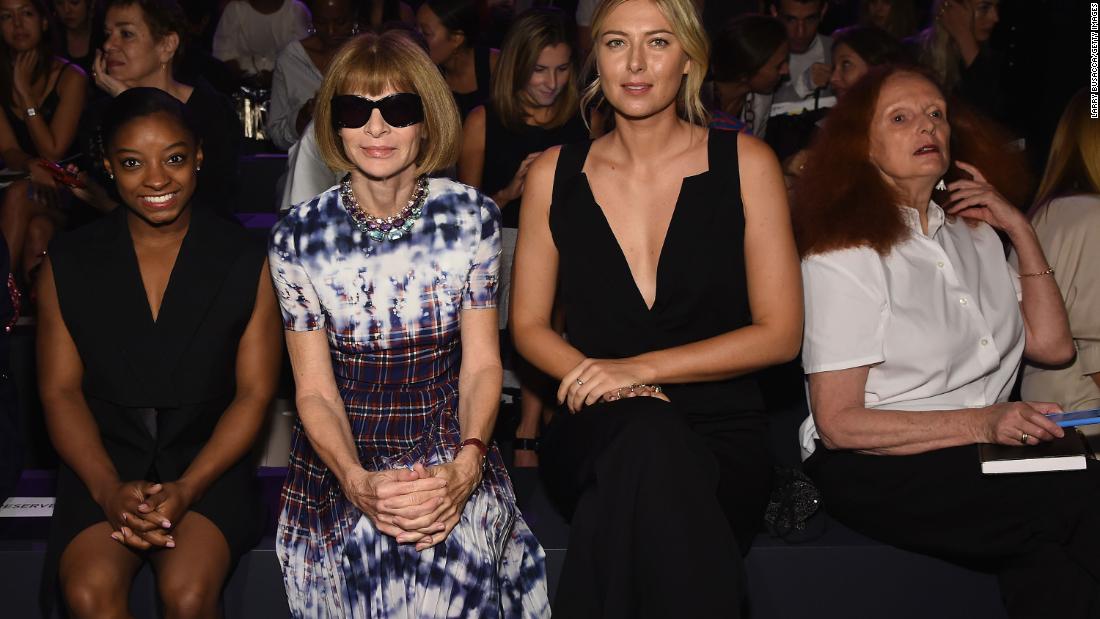 Biles sits with Anna Wintour and Maria Sharapova during New York Fashion Week in September 2016.