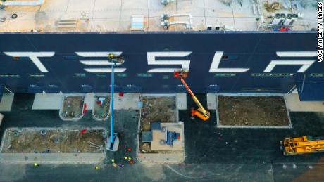 Workers on cranes installing a logo at the Tesla Gigafactory 3 earlier this month in Shanghai.