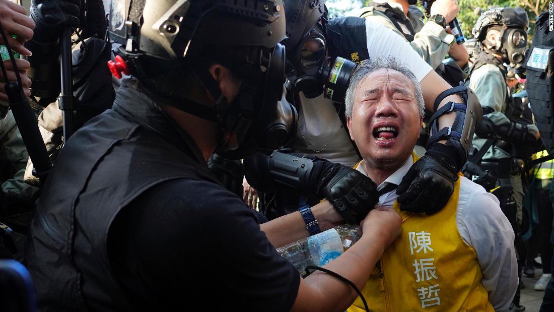Richard Chan, a candidate for the district council elections, reacts after being pepper-sprayed by police in Hong Kong on November 2. 