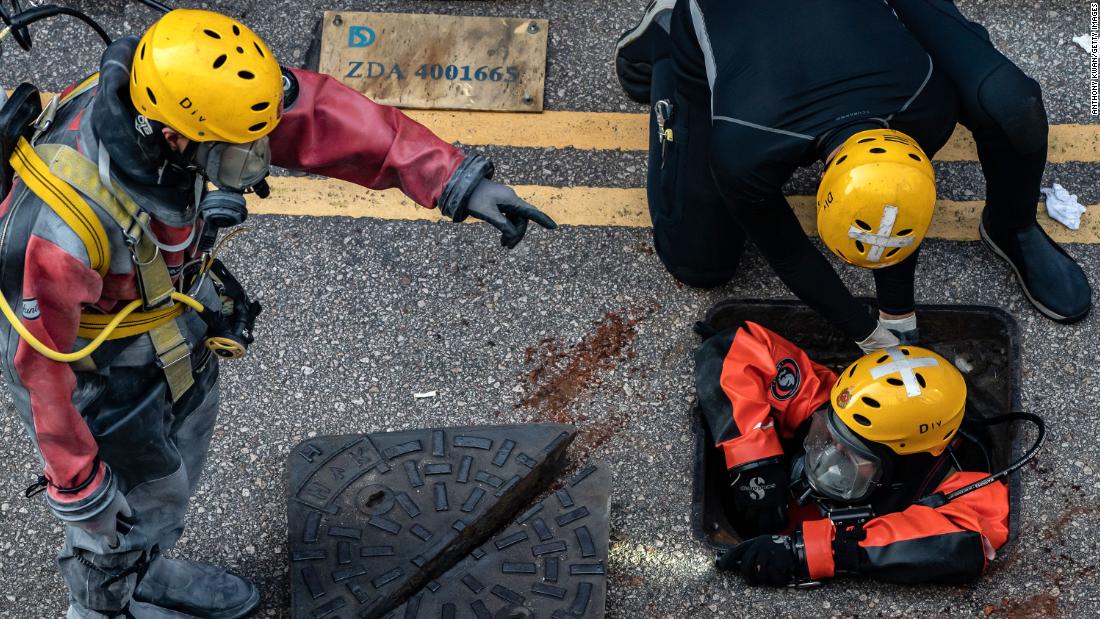 A Fire Services Department rescue diver prepares to enter the sewage system on November 20 to search for protesters who escaped from the Hong Kong Polytechnic University.