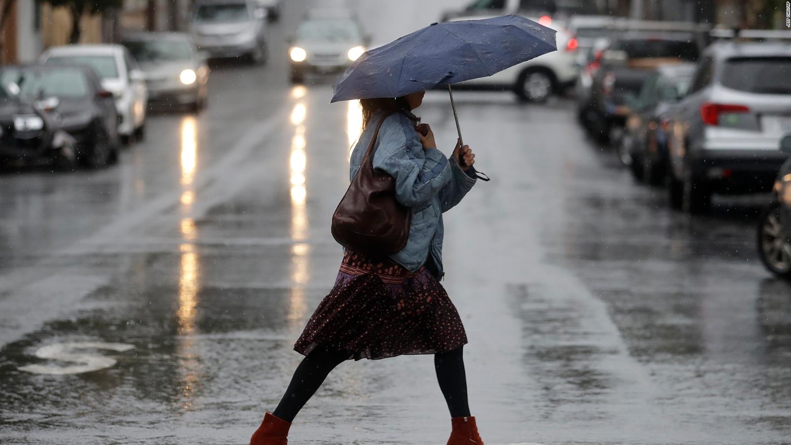 Political News: Political News: A woman walking in the rain in San Francisco Tuesday