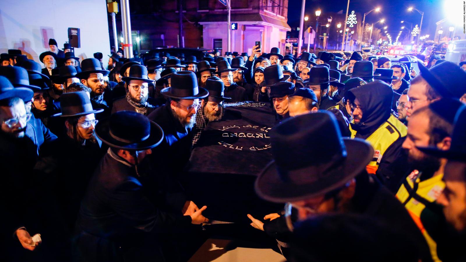 Orthodox Jewish men carry the casket with Mindel Ferencz who was killed in a kosher market that was the site of a gun battle.