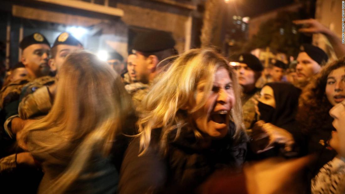 Anti-government protesters scuffle with riot police on December 4 in Beirut.