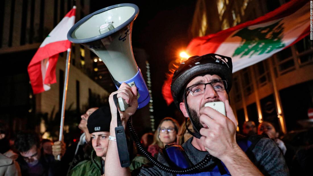 A Lebanese protester speaks into a megaphone on December 16 as demonstrators gather near the home of caretaker Prime Minister Saad Hariri in Beirut.