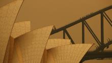 People join a guided climb of the Sydney Harbour Bridge as bushfire haze darkens the sky on December 6.