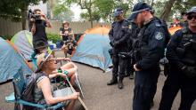 Police disperse demonstrators during a climate protest near Australian Prime Minister Scott Morrison's official residence in Sydney, on December 19, during his absence on an overseas holiday, as bushfires burned across the region.
