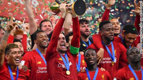 Liverpool captain Jordan Henderson lifts the Club World Cup trophy after his side&#39;s 1-0 extra time victory over Flamengo in Qatar.