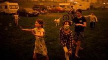 Children evacuated from areas affected by bushfires play at the showgrounds in the southern New South Wales town of Bega on December 31.