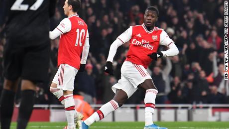 Arsenal&#39;s French-born Ivorian midfielder Nicolas Pepe turns to celebrate after scoring the opening goal of the English Premier League game against Manchester United.