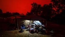 The sky turns red during the day in Mallacoota, Australia. People in the Foreshore Caravan Park are staying through what will be a day of severe fire conditions with large fires still burning out of control to the north of the town.