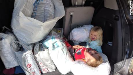 Tyler and his sister, Addison, with a trunk full of bedding donations. 