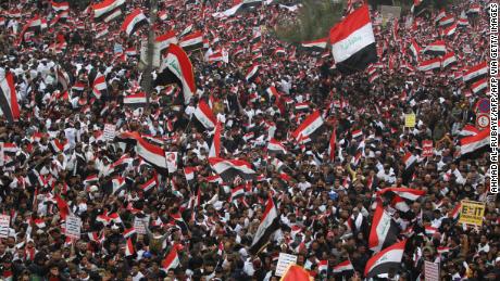 Thousands of Iraqis, waving national flags, take to the streets in central Baghdad on January 24, 2020 to demand the ouster of US troops from the country.
