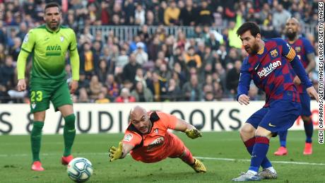 Lionel Messi slots home his fourth goal past a despairing Eibar goalkeeper in the closing stages of the 5-0 win at the Camp Nou.