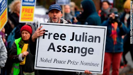 Supporters of WikiLeaks founder Julian Assange, hold placards calling for his freedom outside Woolwich Crown Court in southeast London on February 24, 2020, ahead of the opening of the full hearing into a US request for Assange&#39;s extradition. 