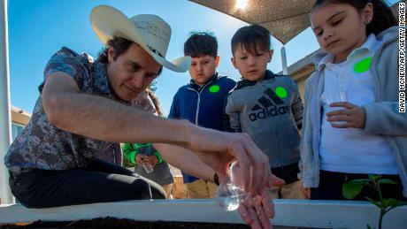 Kimbal Musk teaches students how to plant a vegetable garden in California.