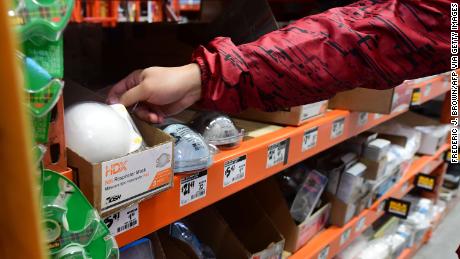 A man reaches out for a mask at a Home Depot store in Los Angeles, California on January 22, 2020 as the Coronavirus entered the United States this week. - A new virus that has killed nine people, infected hundreds and has already reached the US could mutate and spread, China warned on January 22, as authorities urged people to steer clear of Wuhan, the city at the heart of the outbreak. (Photo by Frederic J. BROWN / AFP) (Photo by FREDERIC J. BROWN/AFP via Getty Images)