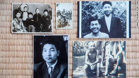 Photos of Iwao Hakamada spread along the tatami mat at his home in Hamamatsu.