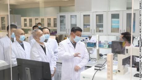 Chinese President Xi Jinping learns about the progress on a candidate coronavirus vaccine during his visit to the Academy of Military Medical Sciences in Beijing on March 2, 2021. 