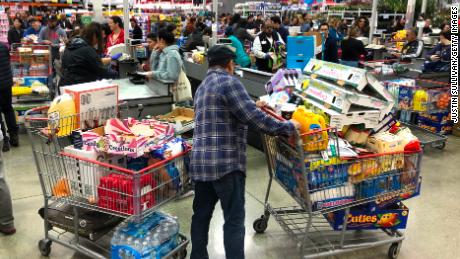  A Costco customer stands by his two shopping carts at a Costco store on March 13 in Richmond, California