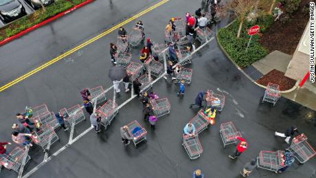 Hundreds of people line up to enter a Costco store on March 14, 2020, in Novato, California. 