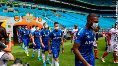 Spieler von Gremio betreten das Feld mit Masken vor dem Spiel gegen Sao Luiz.