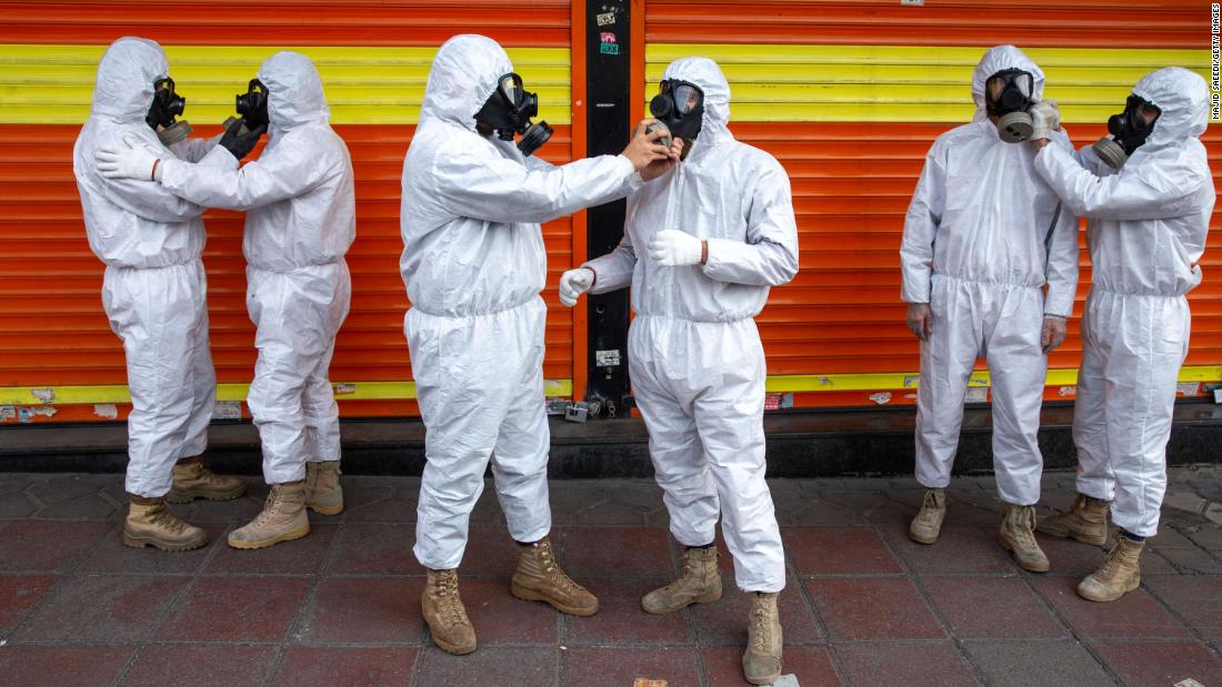 Members of Iran&#39;s Revolutionary Guard prepare to take part in disinfecting the city of Tehran on March 25. 
