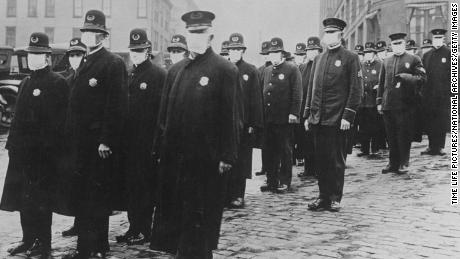 Seattle policemen wear face masks during the influenza epidemic of 1918, which claimed millions of lives worldwide.