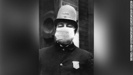 An American policeman wearing a &quot;flu mask&quot; to protect himself from the outbreak of Spanish Flu following World War I.   