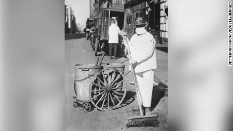 A New York Street cleaner wearing a mask to check the spread of the influenza epidemic. &quot;Better be ridiculous then dead,&quot; is the view of one official. 