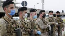 Lebanese soldiers, wearing protective equipment, stand guard at Beirut international airport on April 5, ahead of the arrival of returning nationals.