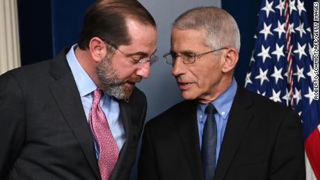 Health and Human Services Secretary Alex Azar (L) and Director of the National Institute of Allergy and Infectious Diseases at the National Institutes of Health Anthony Fauci speak before President Donald Trump arrives for a press conference on the coronavirus.