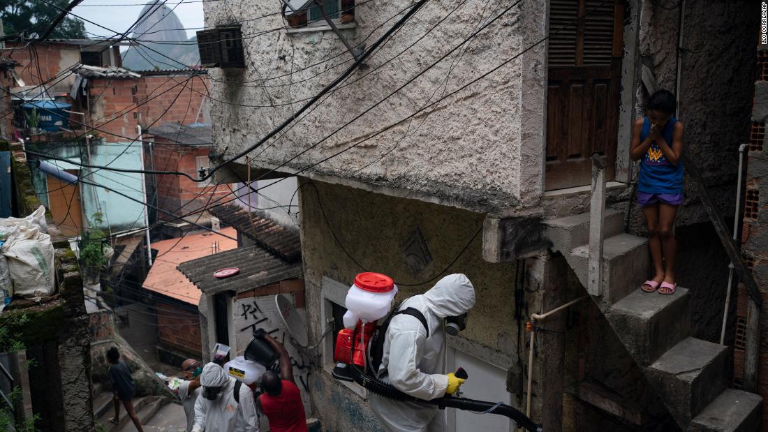 Volunteers spray disinfectant in a favela in Rio de Janeiro on April 10.